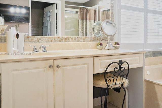 bathroom with vanity and decorative backsplash