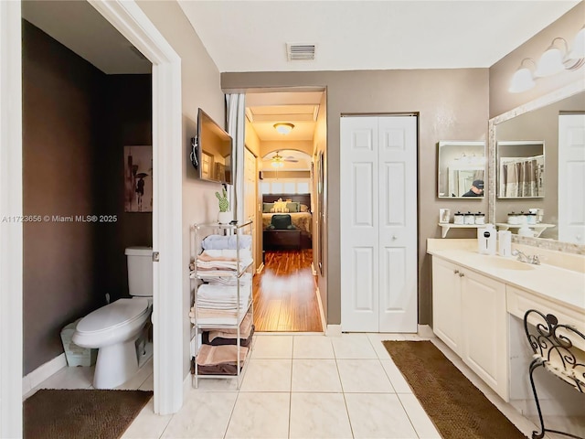 bathroom featuring toilet, vanity, and tile patterned floors