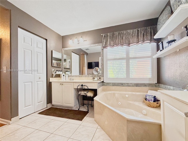 bathroom with vanity, a tub, and tile patterned floors