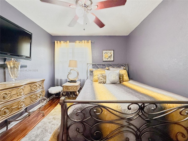 bedroom with ceiling fan and hardwood / wood-style floors