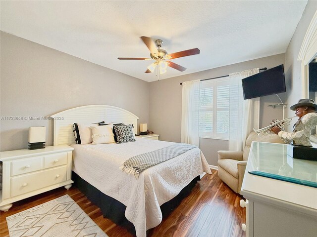 bedroom featuring ceiling fan and dark wood-type flooring