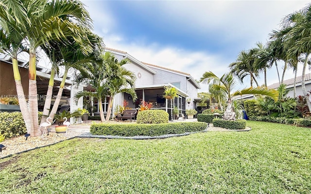 exterior space featuring a sunroom and a front lawn