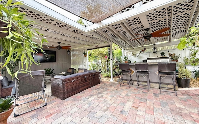 view of patio / terrace featuring ceiling fan and an outdoor bar