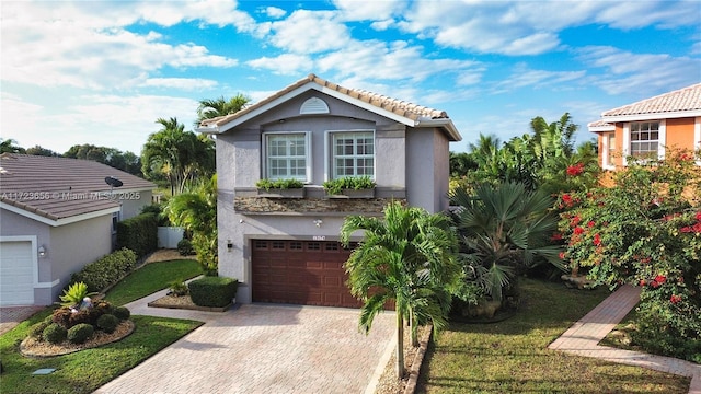 view of front of property featuring a front yard and a garage