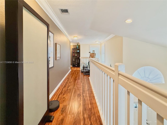 corridor featuring crown molding and wood-type flooring