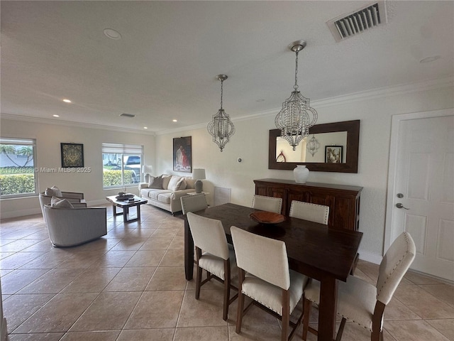 dining area featuring ornamental molding, light tile patterned floors, and a healthy amount of sunlight