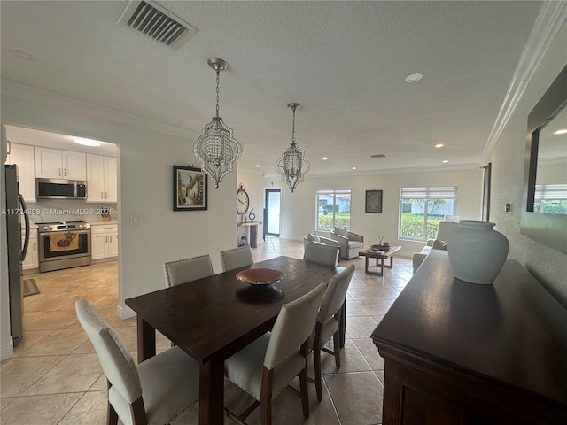 dining room with a notable chandelier, ornamental molding, and light tile patterned floors