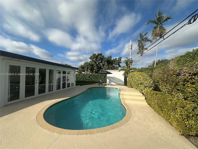 view of pool with a patio area and french doors