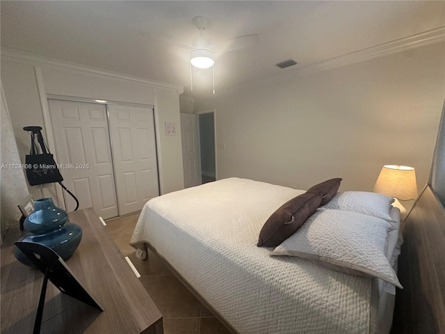 bedroom with ceiling fan, a closet, and crown molding