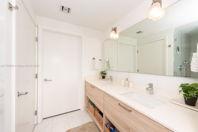 bathroom featuring a shower with shower door and vanity