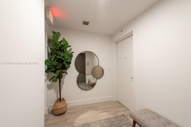 hallway with light hardwood / wood-style flooring