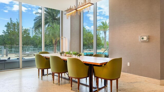 dining space featuring a wall of windows and a wealth of natural light