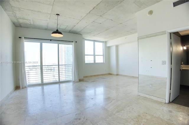 unfurnished room featuring visible vents