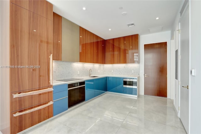 kitchen featuring sink, black electric cooktop, and backsplash