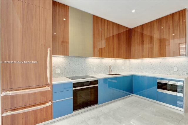 kitchen featuring light tile patterned flooring, black appliances, decorative backsplash, and sink