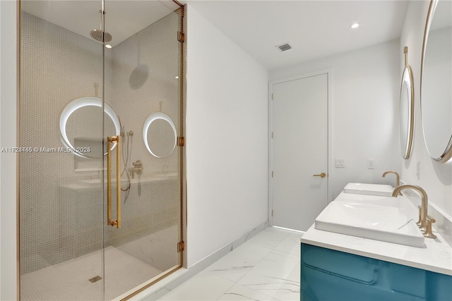 bathroom with vanity and a shower with shower door