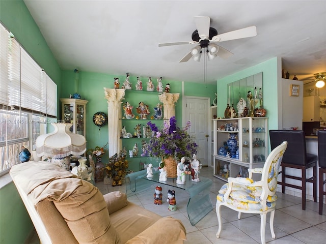 tiled living room with ceiling fan