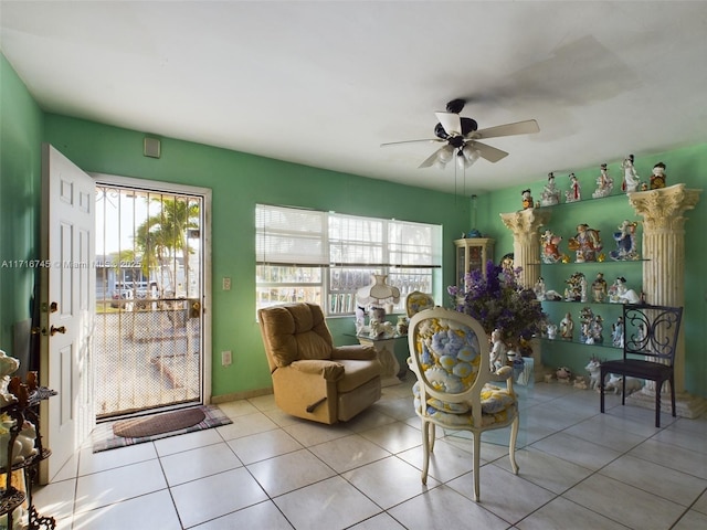 living area featuring ceiling fan and light tile patterned flooring