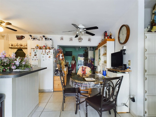 dining area with ceiling fan and light tile patterned flooring