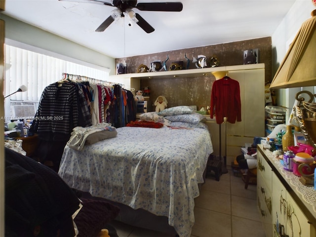 bedroom featuring ceiling fan, light tile patterned flooring, and cooling unit