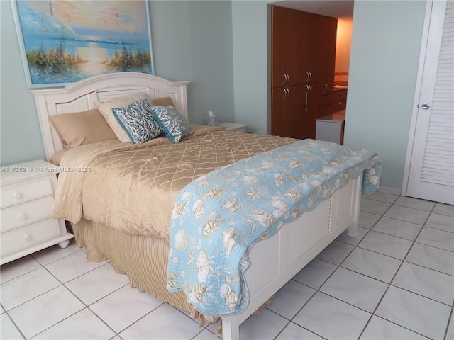 bedroom with light tile patterned floors