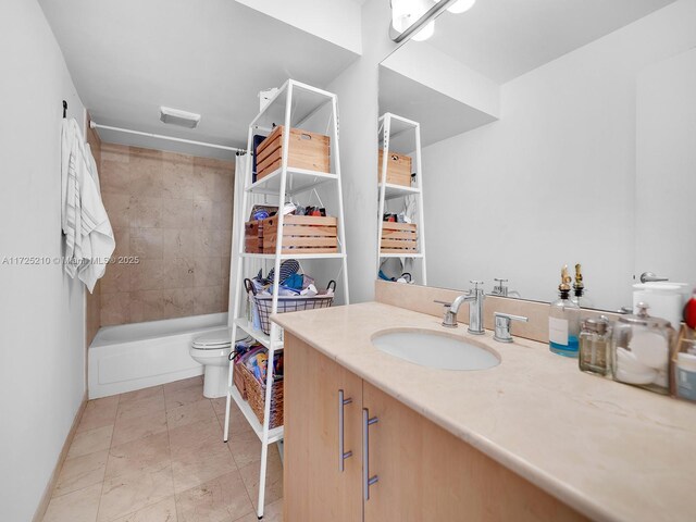 full bathroom with toilet, vanity, tile patterned floors, and tiled shower / bath