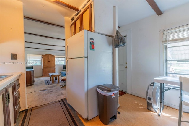 kitchen featuring white fridge and beam ceiling