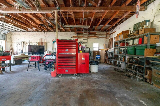 interior space featuring concrete floors and a workshop area