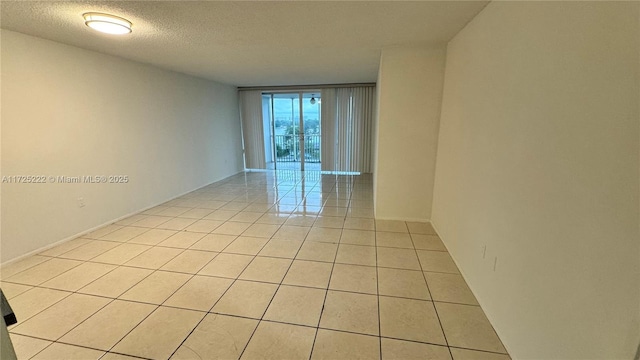 tiled spare room with a textured ceiling