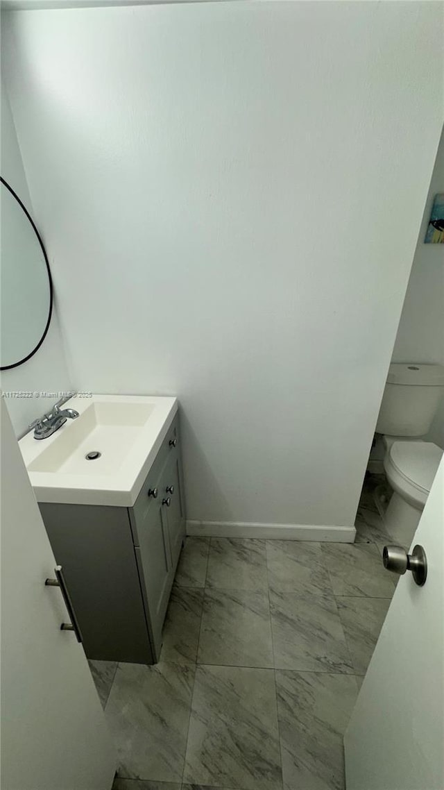 bathroom with toilet and vanity