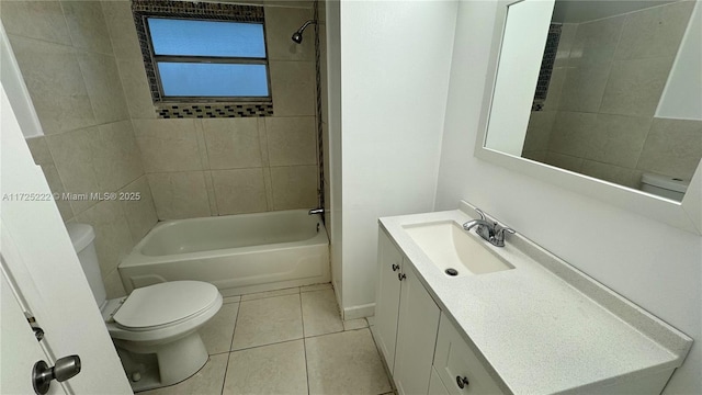 full bathroom featuring vanity, tiled shower / bath combo, tile patterned floors, and toilet