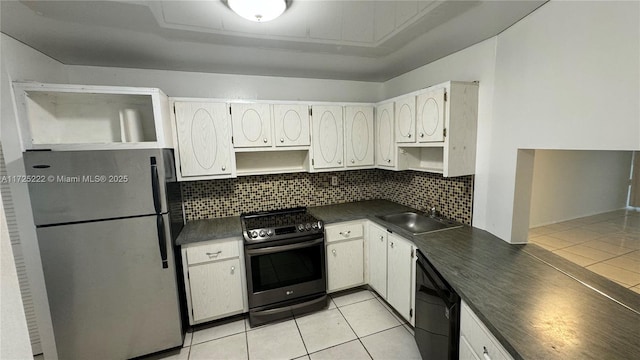 kitchen with stainless steel appliances, light tile patterned floors, backsplash, white cabinets, and sink