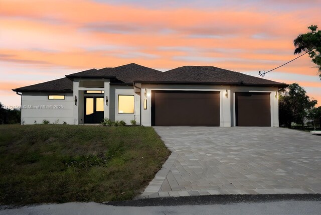 prairie-style house with a lawn and a garage