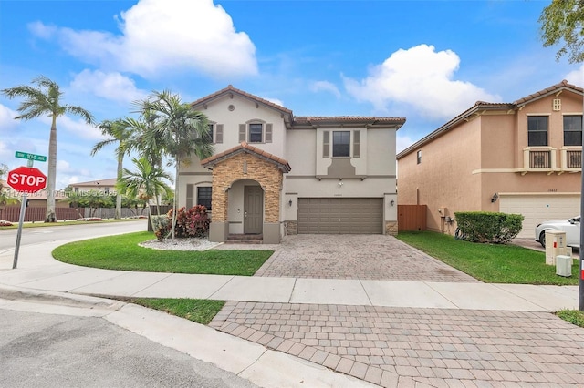 mediterranean / spanish house featuring a garage and a front lawn