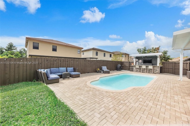 view of pool featuring a bar, a patio, and outdoor lounge area