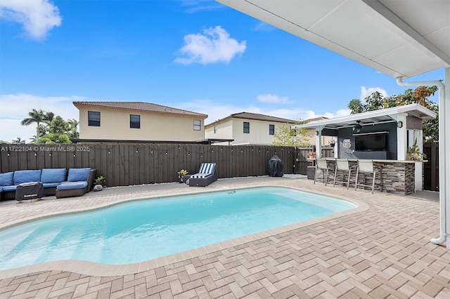 view of swimming pool featuring a patio area, exterior bar, and outdoor lounge area