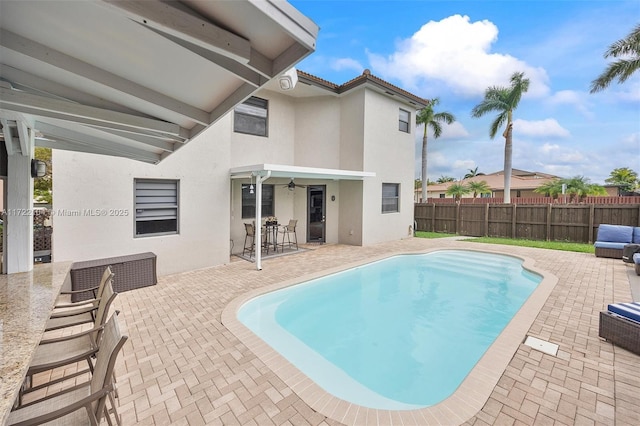 view of pool featuring a patio and ceiling fan