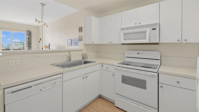 kitchen featuring white cabinetry, white appliances, and decorative light fixtures