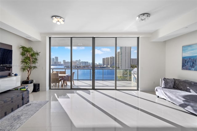 bedroom with light tile patterned flooring, expansive windows, and a water view