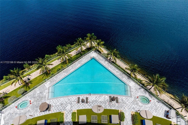 birds eye view of property with a water view