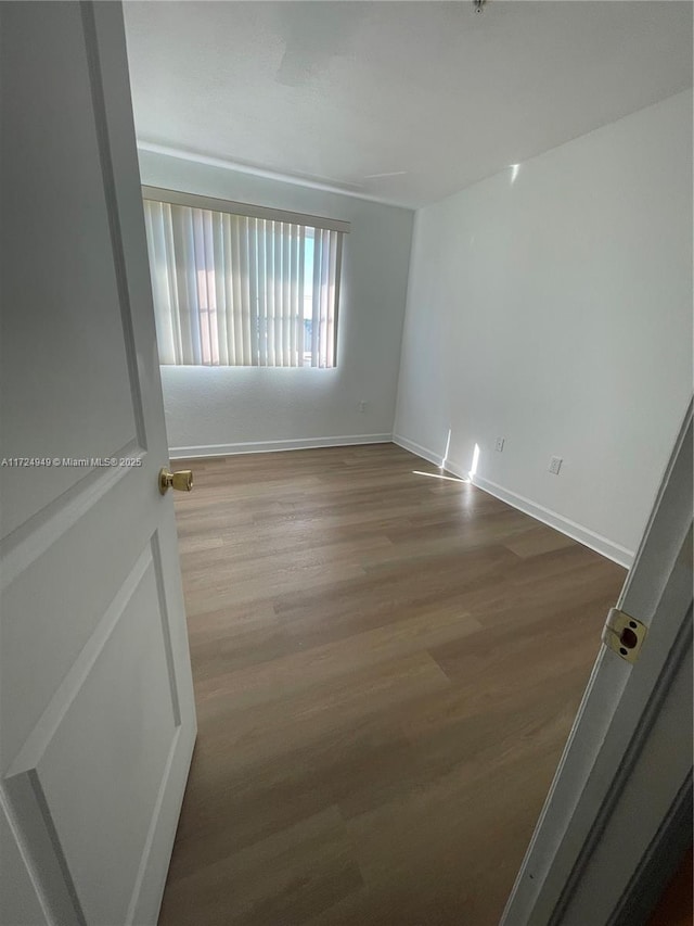 unfurnished room with hardwood / wood-style floors