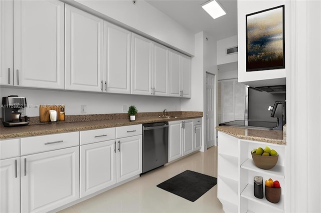 kitchen with stainless steel dishwasher, white cabinets, and light tile patterned flooring