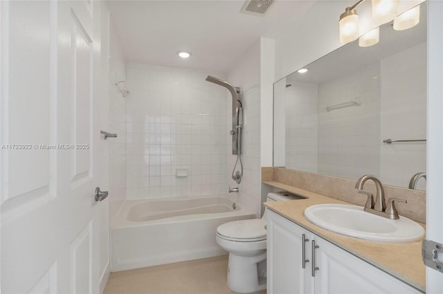 full bathroom with toilet, vanity, and tiled shower / bath