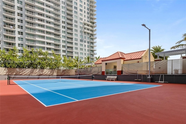 view of tennis court featuring basketball hoop