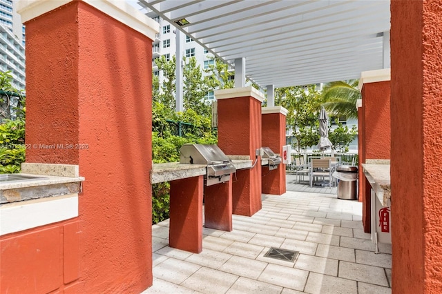 view of patio / terrace featuring exterior kitchen and a pergola