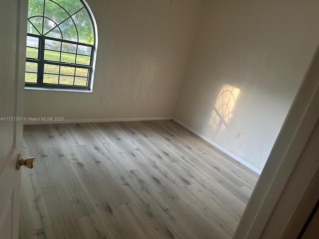 unfurnished room with light hardwood / wood-style floors