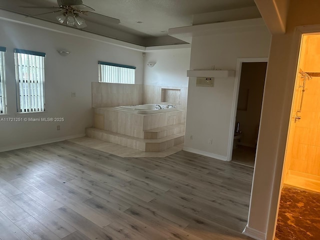 empty room featuring ceiling fan and hardwood / wood-style floors