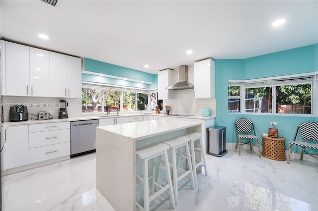 kitchen featuring black electric cooktop, white cabinets, wall chimney range hood, stainless steel dishwasher, and backsplash