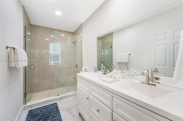 bathroom featuring an enclosed shower and vanity