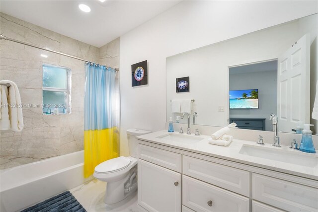 full bathroom with toilet, shower / bath combo with shower curtain, and vanity